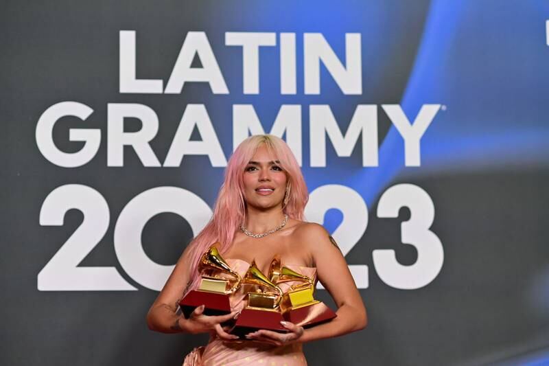 SEVILLE, SPAIN - NOVEMBER 16: Karol G poses with the awards for Best Recording of the Year, Best Urban Album of the Year, and Best Album of the Year in the media center for The 24th Annual Latin Grammy Awards  at FIBES Conference and Exhibition Centre on November 16, 2023 in Seville, Spain. (Photo by Niccolo Guasti/Getty Images)
